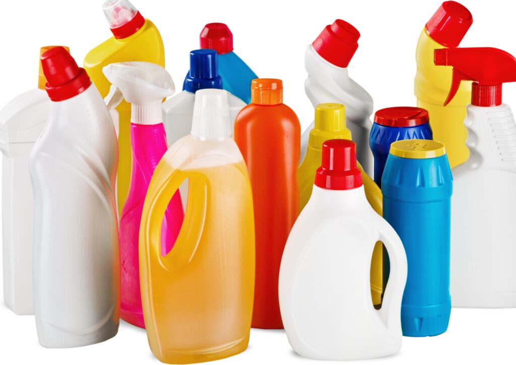 A plastic bottle for cleaning solutions is used in pressure washing, showcasing various shapes, sizes, and vibrant red, blue, yellow, and white caps.